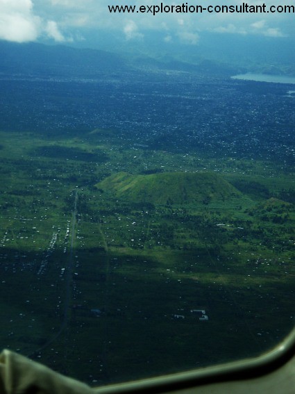 Aerial view of Goma seen from the north west; front: black lava of the 2002 erupotion; center:adventive craters; rear: city of Goma and Lake Kivu; the mountains belong to Rwanda